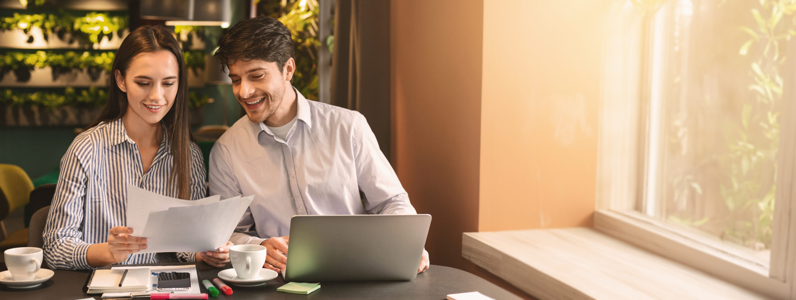 Millennial coworkers having business lunch at cafe